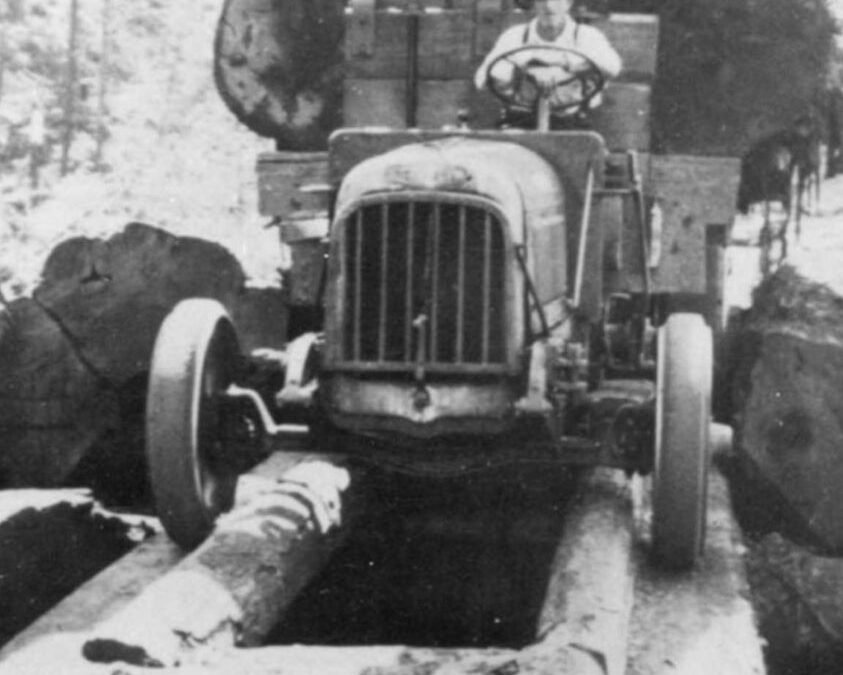 A Federal Logging Truck Hauling Timber Over A Log Bridge